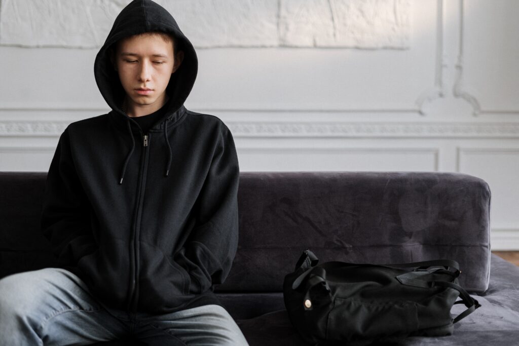 depressed teen in black hoodie